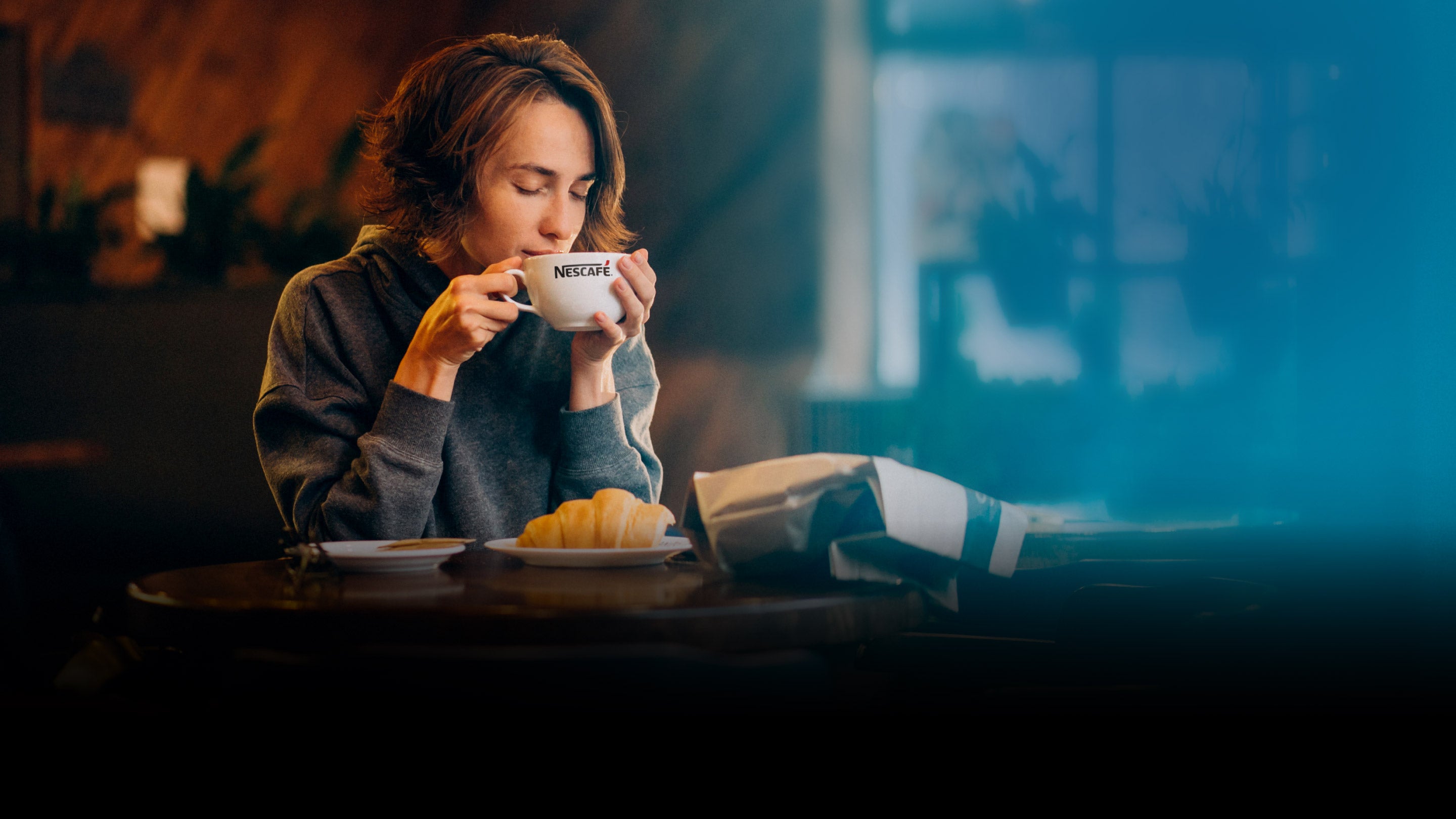 Woman having a cup of Nescafe coffee.