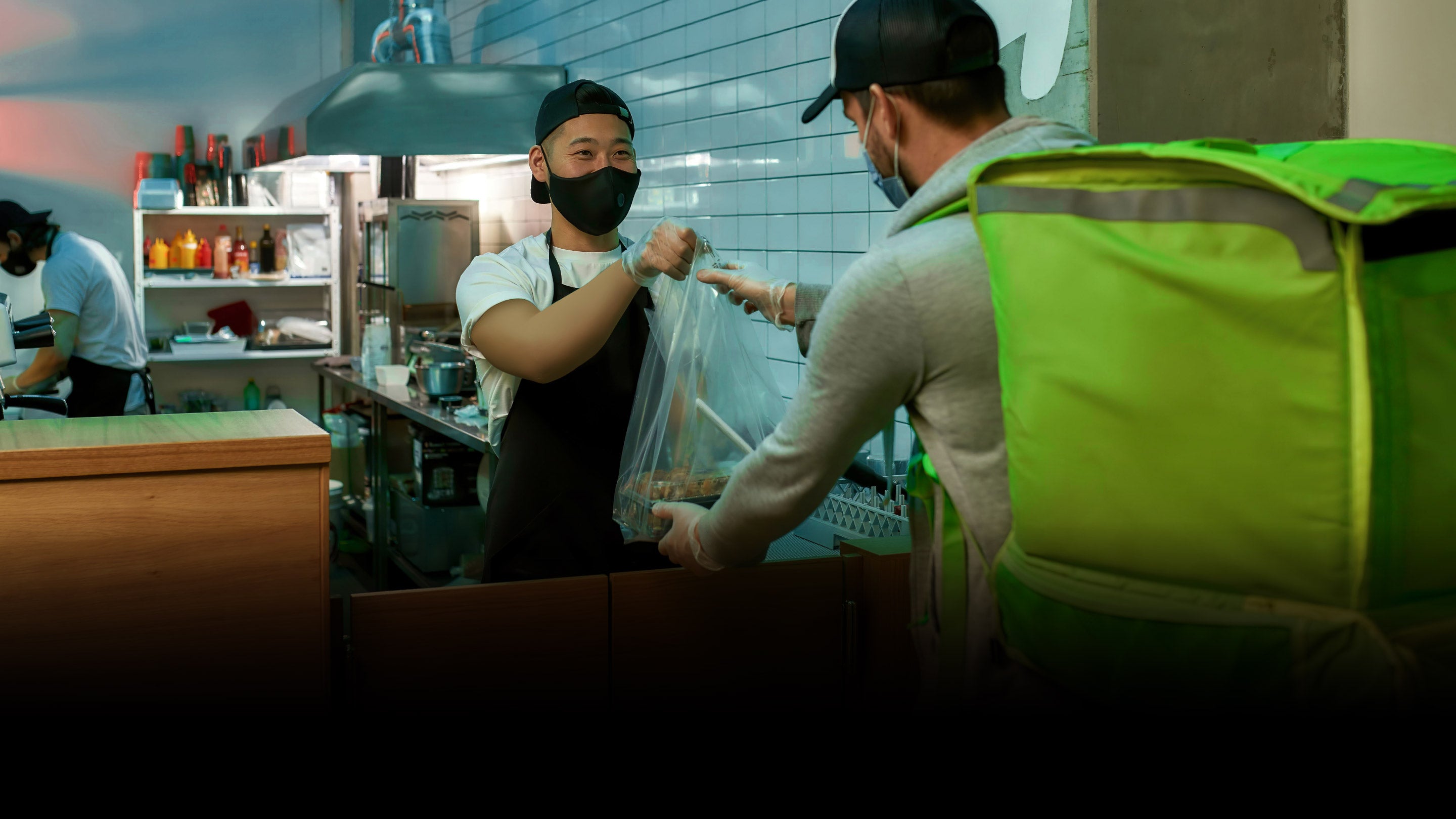 Delivery man getting food at the restaurant.