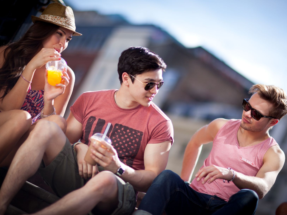Group of friends drinking orange juice