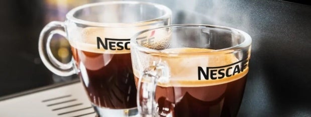 Two cups hot coffee on beverage machine