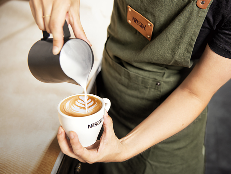 Barista making latte art.