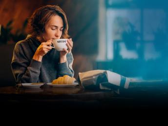 Woman having a cup of Nescafe coffee.