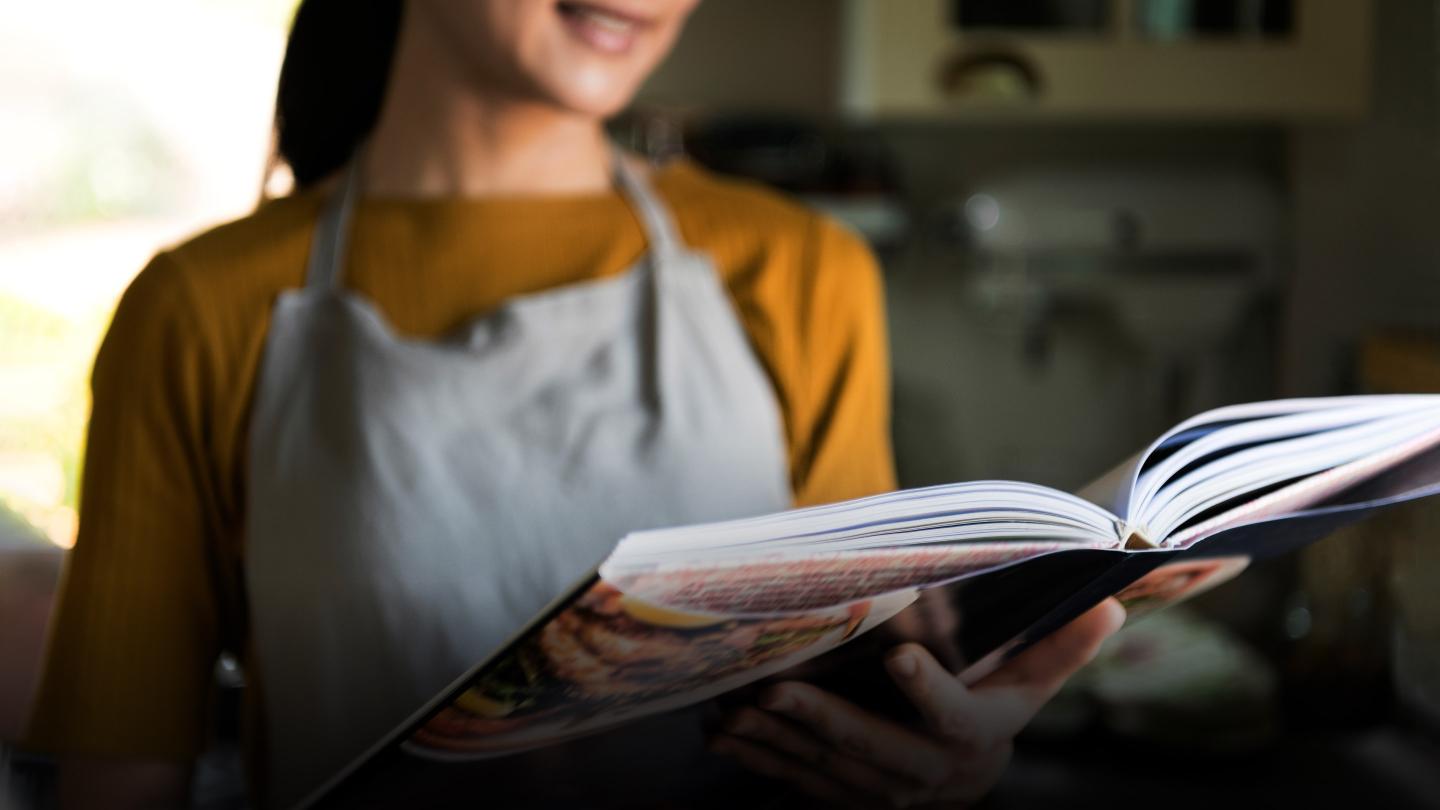 Woman reading recipe book